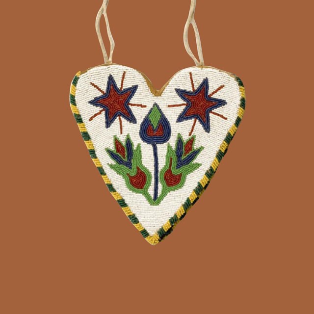 Heart shaped beaded bag by Native artist on dark orange background