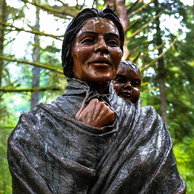 statue of native woman with baby on her back