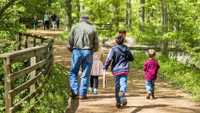 family hiking park trail