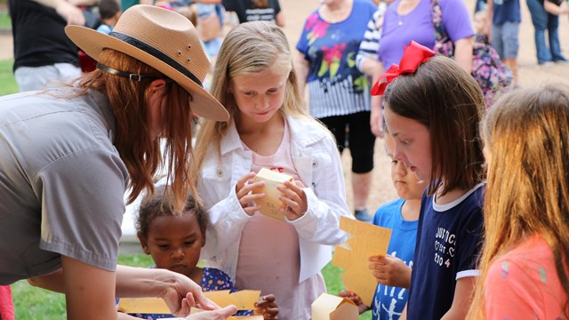 Park Ranger and kids doing a craft activity 