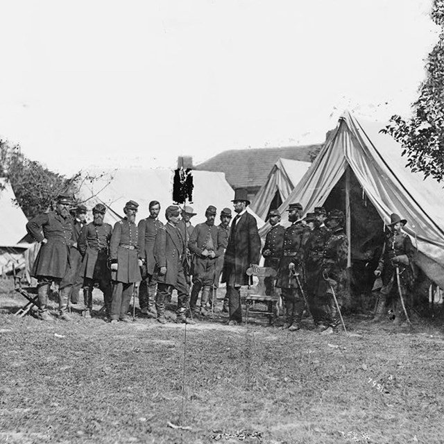 Lincoln standing with Union soldiers in a Union camp at Antietam