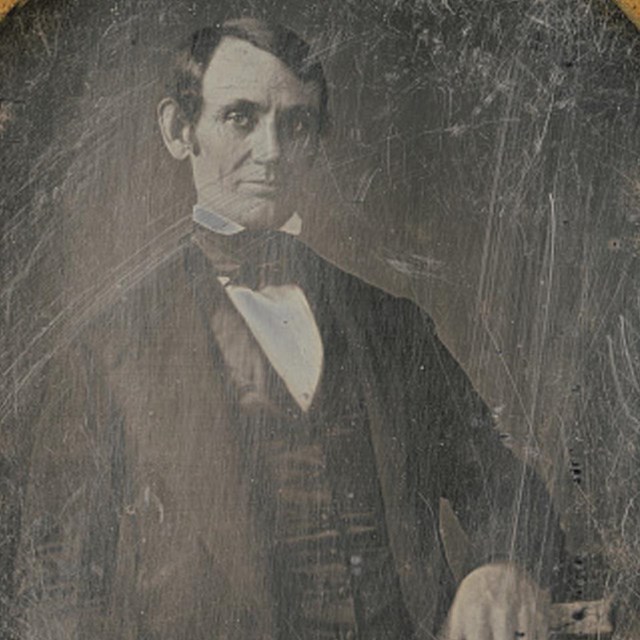 Young Abraham Lincoln, shaven, with dark hair slicked to right
