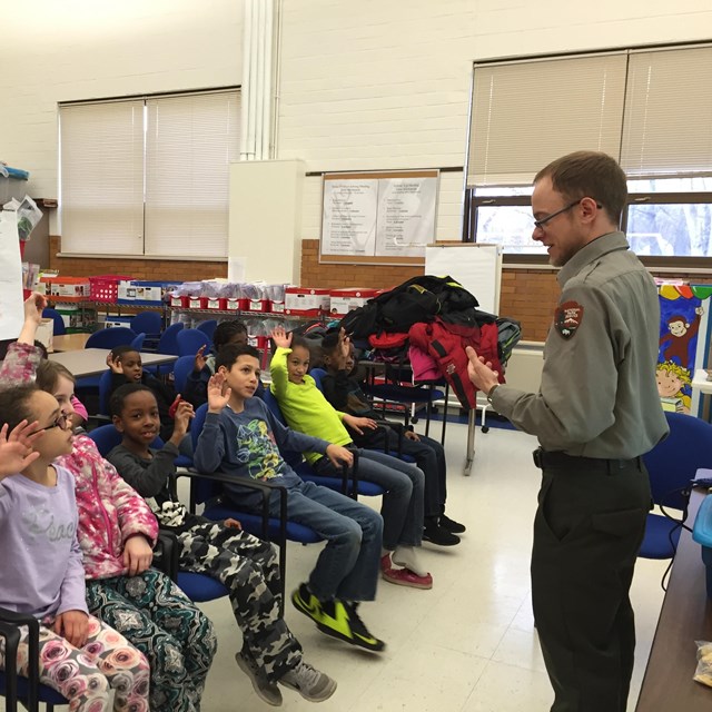 A ranger talks to a group of students 