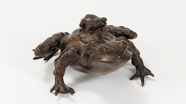 Bronze frog sculpture with small frog on its back