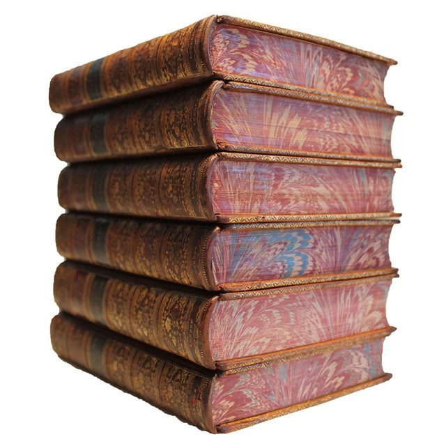 Stack of six books with leather covers and marbled edges visible