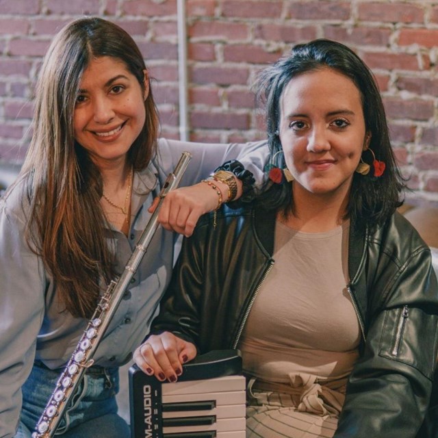Two women seated with flute and keyboard