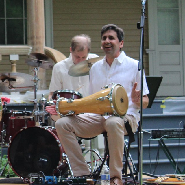 Group of musicians playing on an outdoor stage