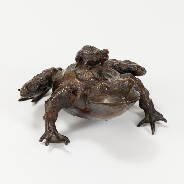 Bronze frog sculpture with small frog on its back