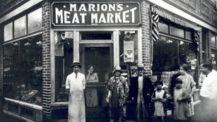 A family poses in front of a historic business in Lowell