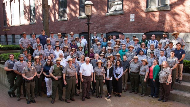 A large group of employees pose together for a picture