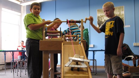 Two boys create a cart at the Tsongas Industrial History Center
