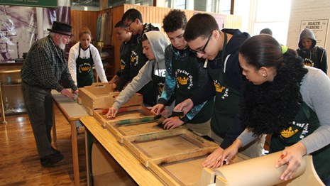 Row of students on an assembly line