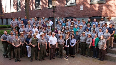 A large group of park service employees pose together for a photo