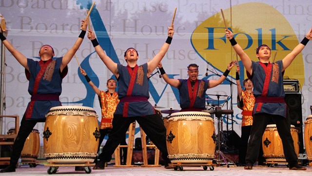 Traditional Japanese drummers perform on an outdoor stage