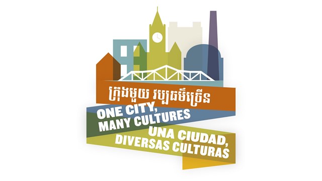 The words One City, Many Cultures written in Khmer, English and Spanish