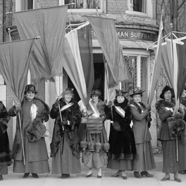 Women holding suffrage banners in Washington D.C.