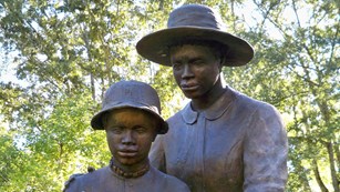 A statue depicting daily life of the formerly enslaved people taking their first steps of freedom
