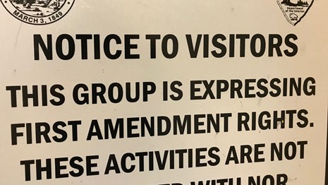 Sign informing visitors that a group is expressing its first amendment rights.
