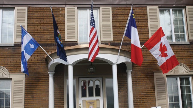 Flags hanging in front of a building