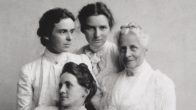 historic black and white photo of a mother and three adult daughters