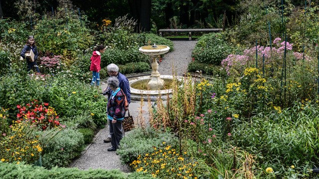 four people wander four square garden