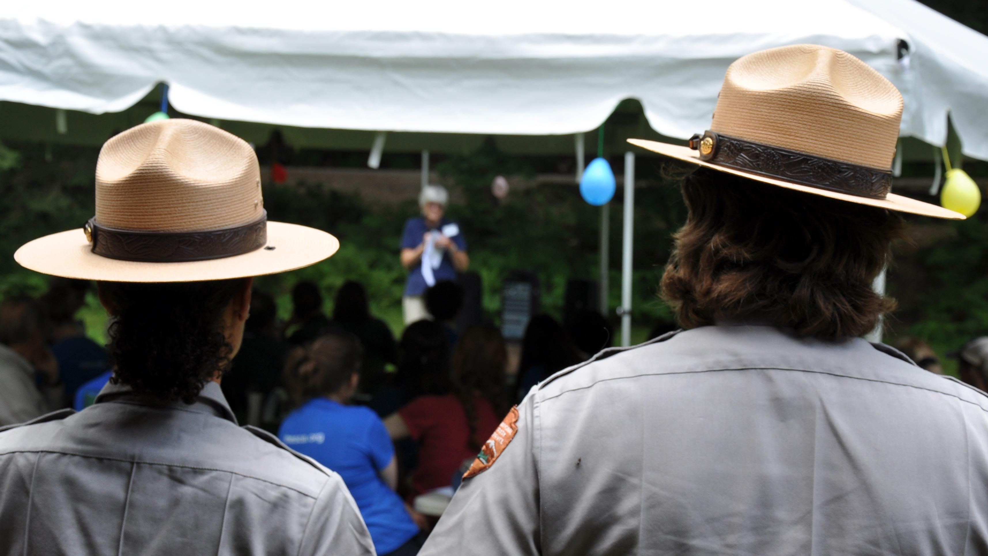 two rangers with flat hats from behind