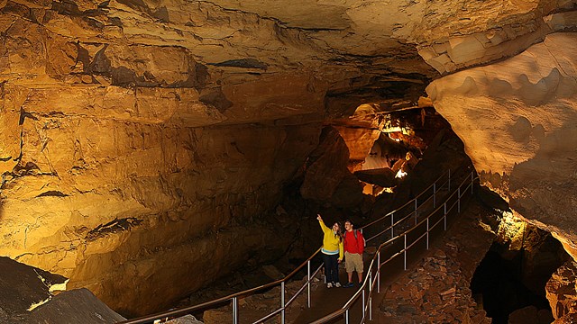 Two park visitors waling along a trail in the cave