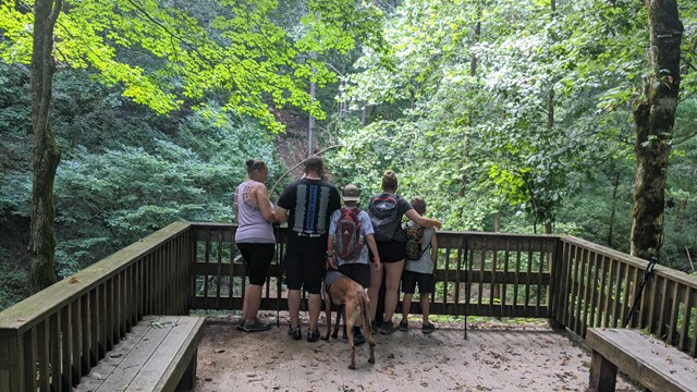 A family looking at a view point. 