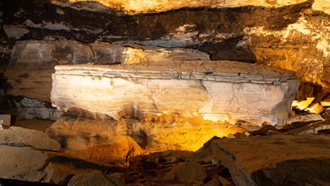 A large rock feature inside a cave passage.