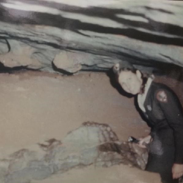 A park ranger walks through the cave. 