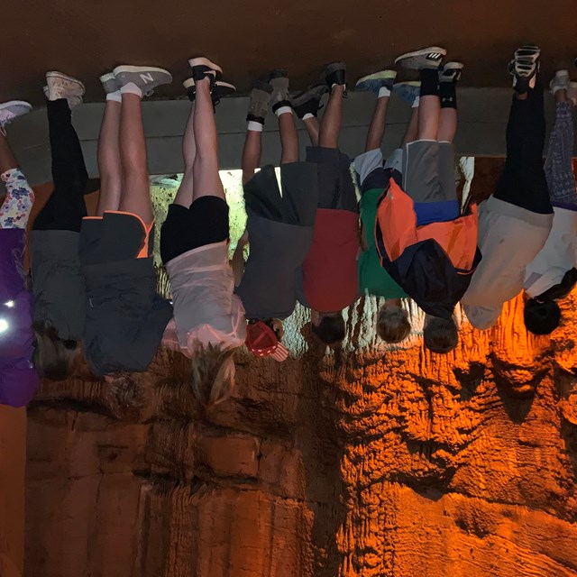 A group of students looking at cave formations.