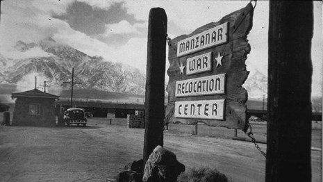 Manzanar War Relocation Center entrance sign with sentry post in the background