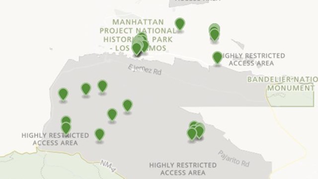 A color photo of a map with green markers.