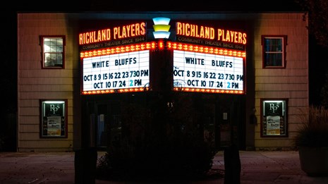  Color photo of a theater with a marquee that reads “ Richland Players: White Bluffs.”