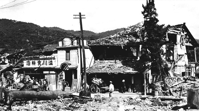 A black and white photo of a building in ruins. 