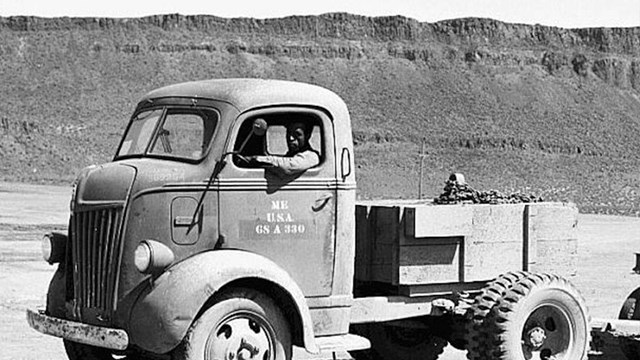 A black and white photo of a truck. 
