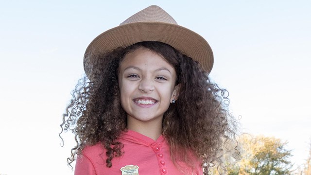 A child in a flat hat. 