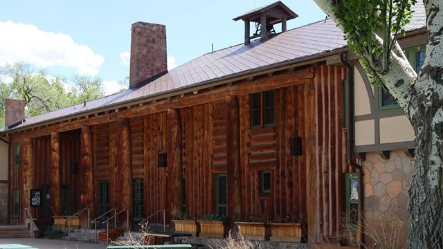 Color photo of Fuller Lodge at Los Alamos, a large wooden lodge.