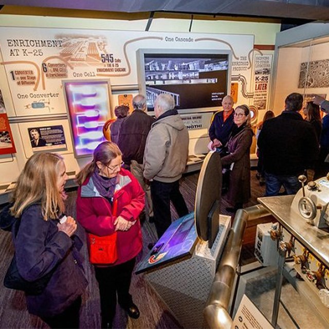 Several people viewing exhibits inside a museum.