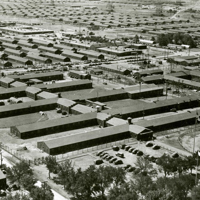 A black and white photo of many rows of trailers. 