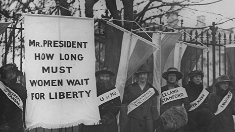 A group of suffragists with signs protesting