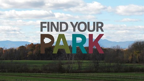 View of farm and mountains in the background with phrase "Find Your Park" 