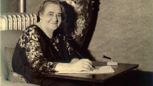 Picture of Maggie L. Walker in a chair with an attached desk