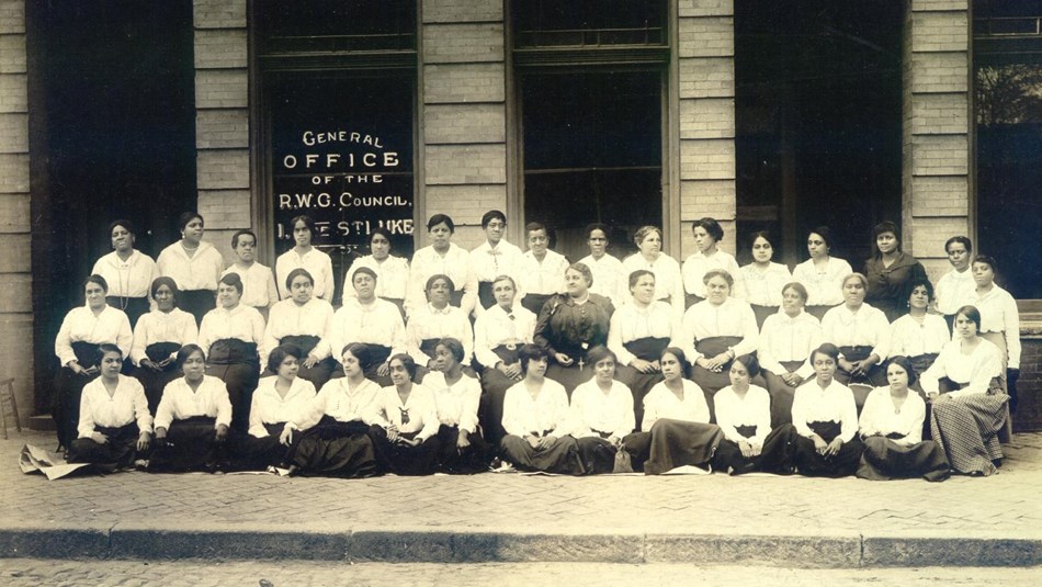 Maggie L. Walker with female St. Luke office staff members in front of St. Luke Hall in 1917