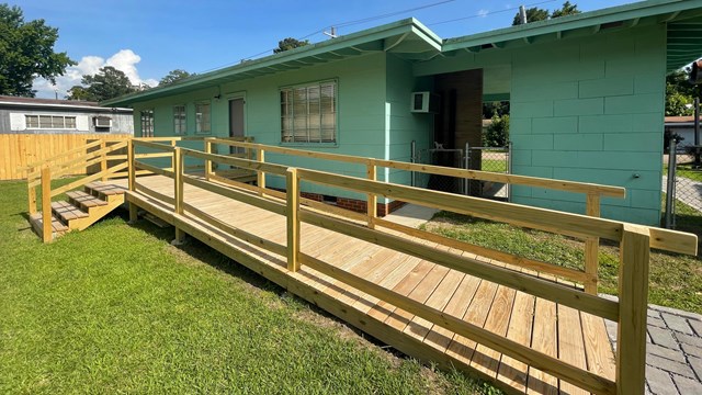 Wooden ramp leads to back door of Evers Home