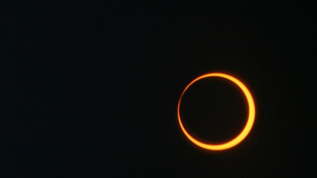 The moon blocks most of the sun, showing a ring of fire around the edge. 
