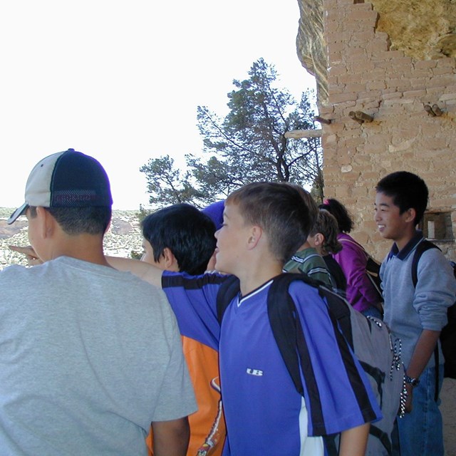 Students visiting a cliff dwelling.