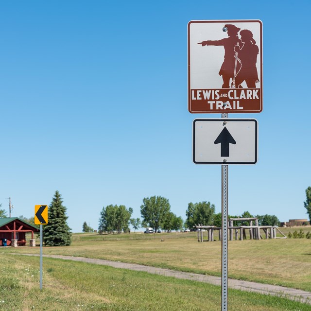 Sign along roadside reads 