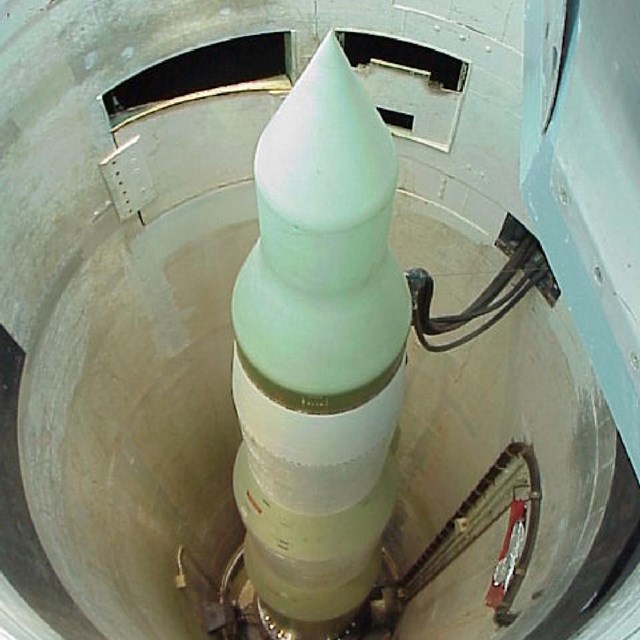 A cylindrical missile inside an underground silo.