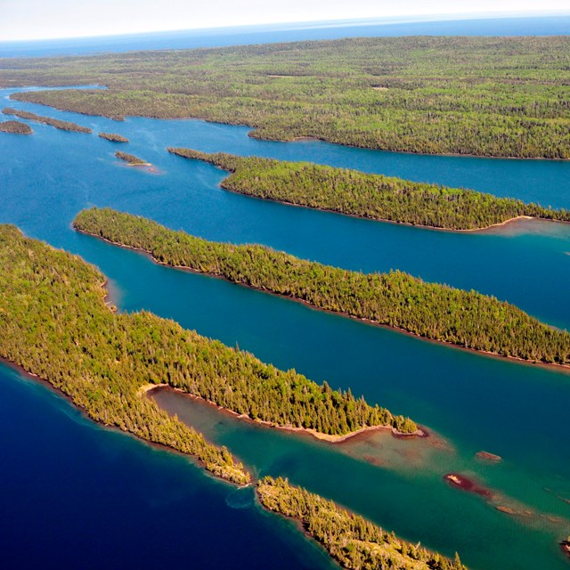 Aerial view of forested islands with narrow waterways. 